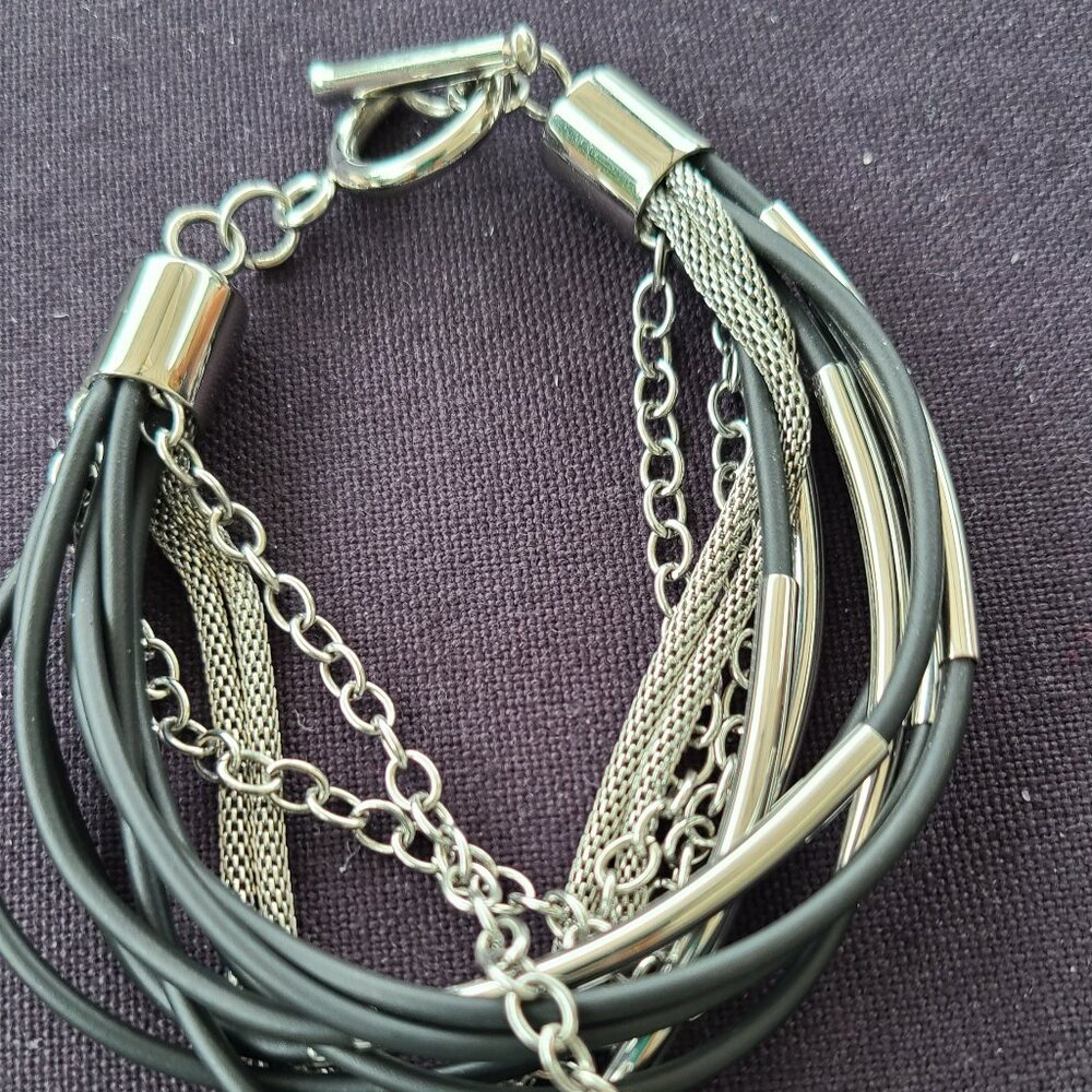 Multi-Strand mixed metal mesh and metal filled black rubber cord bracelet.